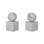 Two marble spheres bookends on square bases against a white background