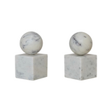 Two marble spheres bookends on square bases against a white background