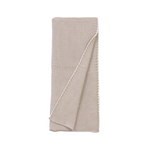 Folded beige knitted blanket on a white background