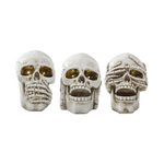 Three skull-shaped resin LED figures with different expressions on a white background