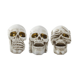 Three skull-shaped resin LED figures with different expressions on a white background
