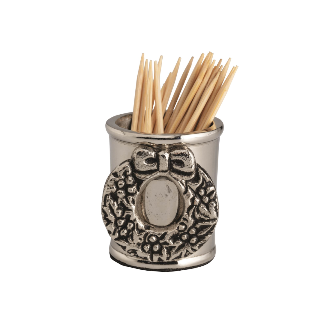 Silver toothpick holder with decorative wreath design on a white background