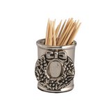 Silver toothpick holder with decorative wreath design on a white background