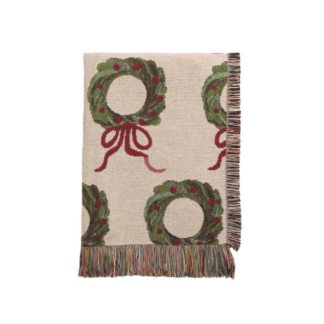 Blanket with Christmas wreath and bow pattern on a beige background