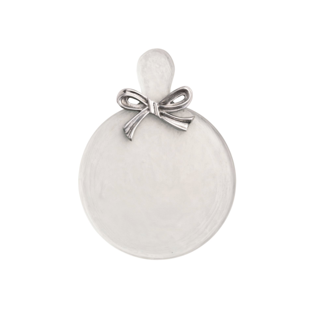 Round white glass charcuterie serving board with a silver bow on a white background