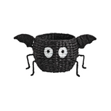 Black spider-shaped basket with eyes and legs on a white background