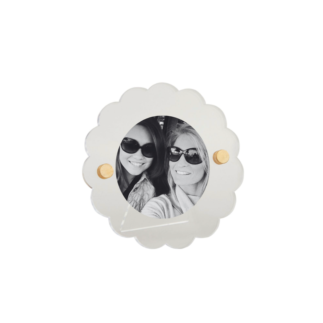 Decorative photo frame with scalloped edge and gold accents on a white background