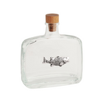 Clear glass bottle with wooden cap and fish design on a white background