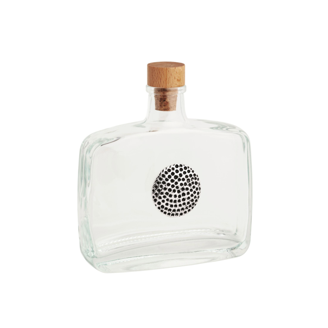 Clear glass bottle with a wooden cap on a white background