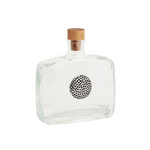Clear glass bottle with a wooden cap on a white background