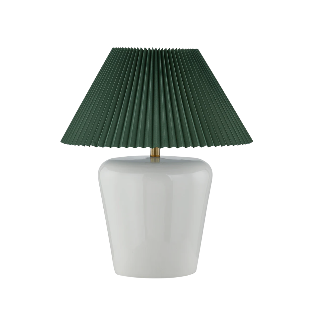 Table lamp with a green pleated shade and white base on a white background