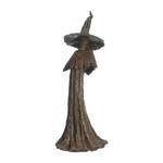 Bronze statue of a witch with a wide hat on a white background