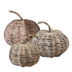 Three woven pumpkins of different sizes on a white background