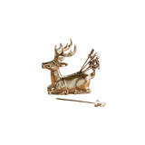 Gold deer-shaped appetizer picks and holder on a white background