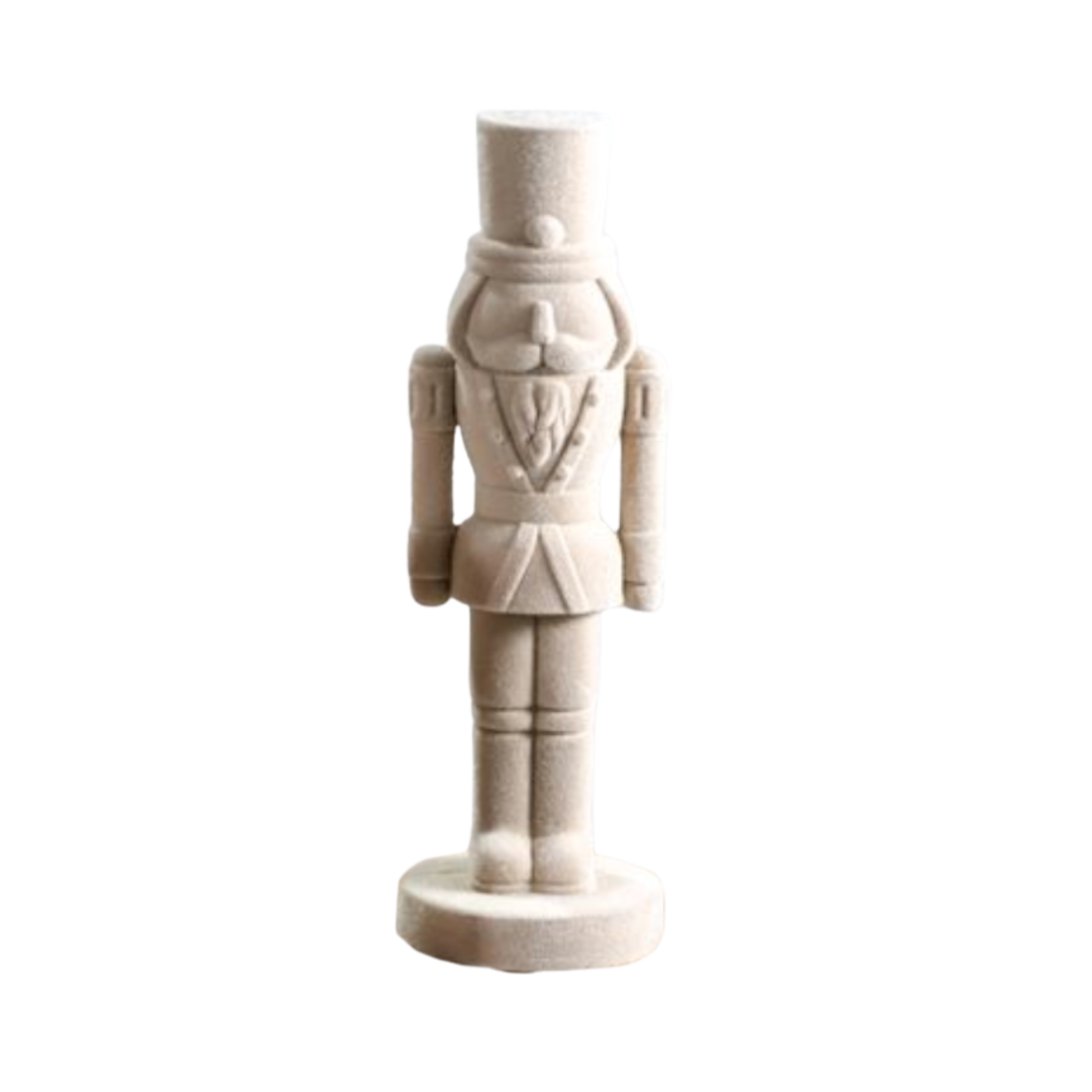White ceramic nutcracker figure on a white background