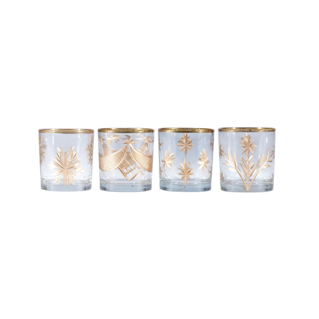 Four glass candle holders with gold accents on a white background