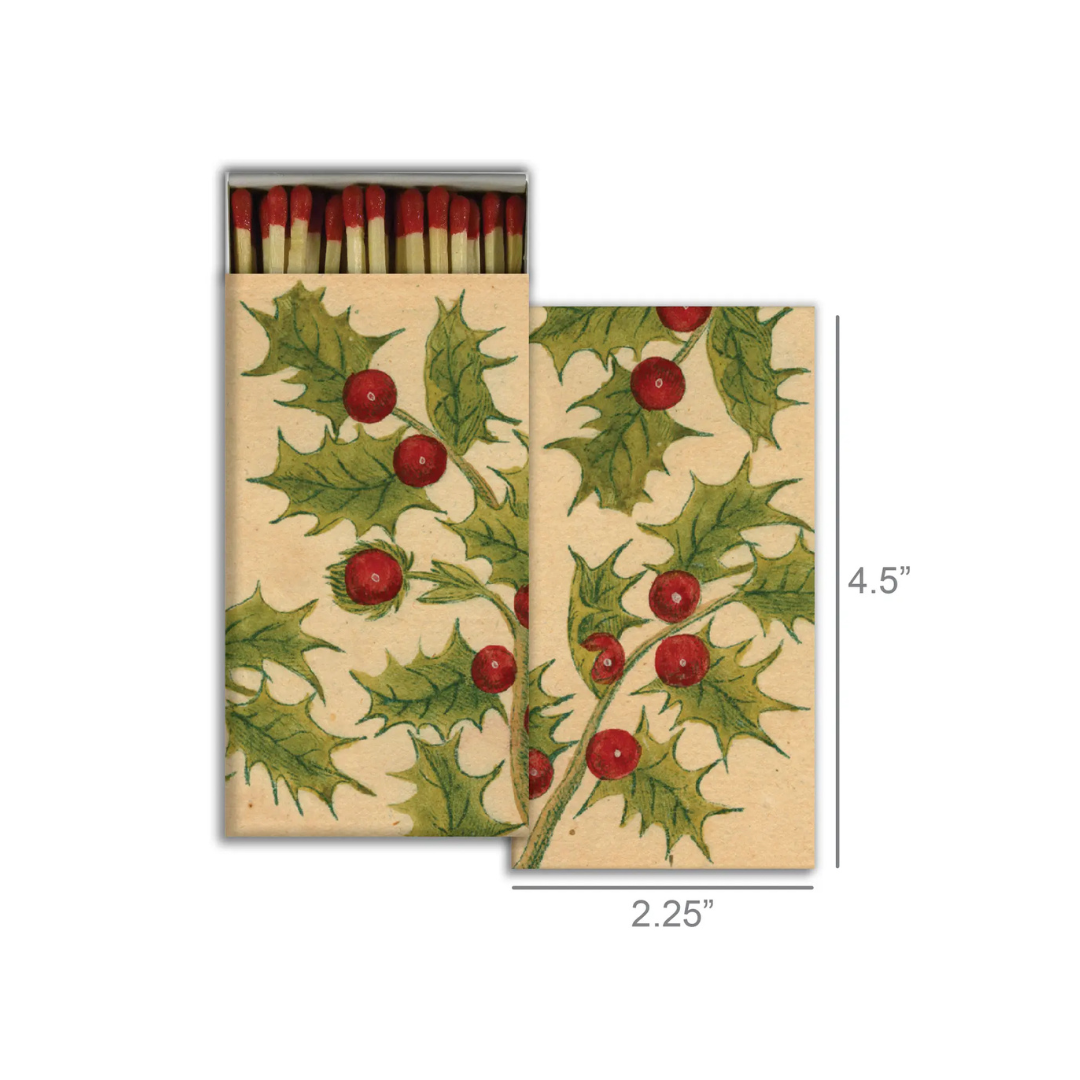 Matchbox with holly design and matches inside on a white background