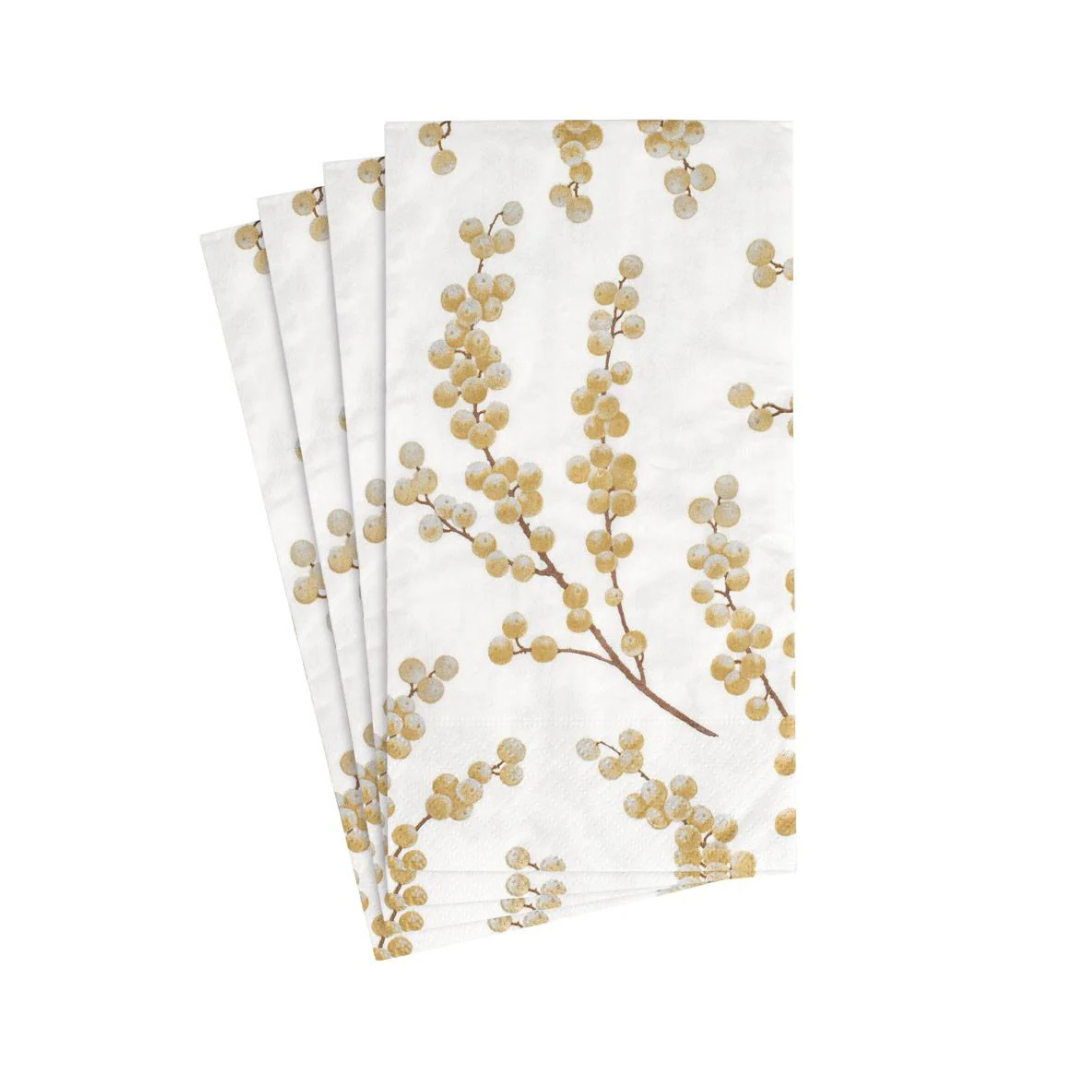 Set of four white napkins with gold leaf design on a white background