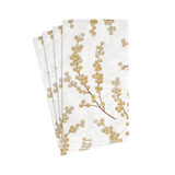 Set of four white napkins with gold leaf design on a white background
