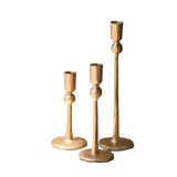 Three gold candle holders on a white background