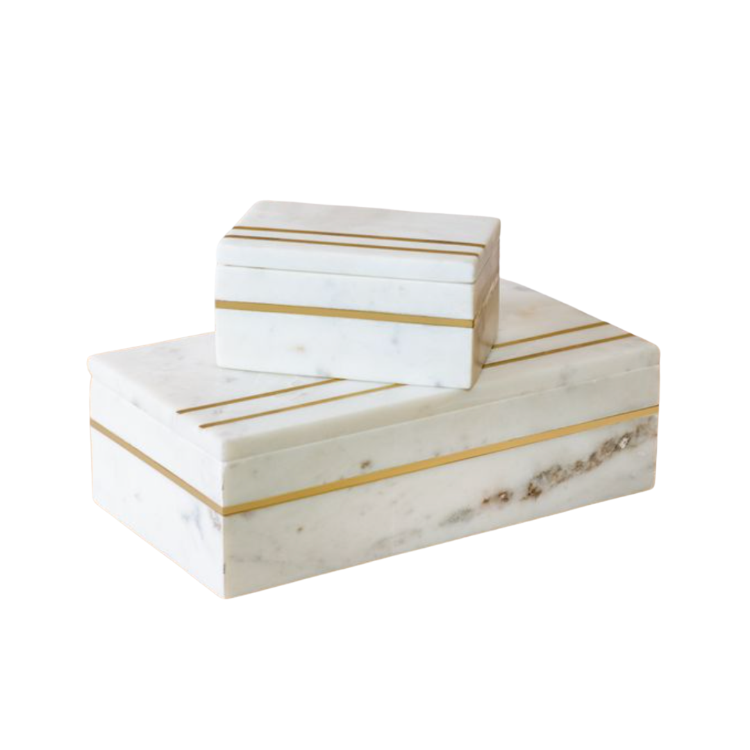Marble boxes with gold stripes on a white background