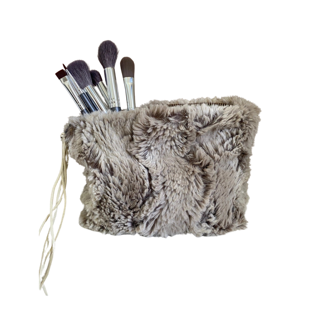 Fluffy makeup brush holder with brushes on a white background