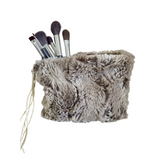 Fluffy makeup brush holder with brushes on a white background