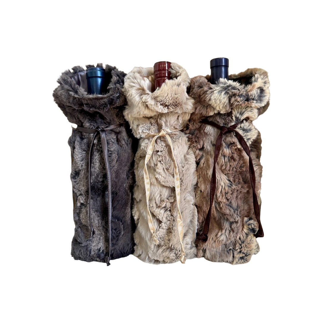 Three faux fur wine bottle covers on a white background