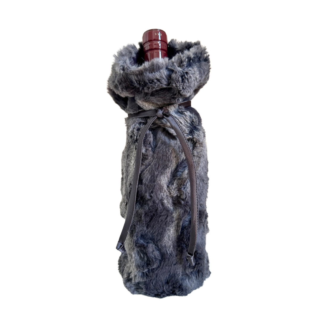 Fur-wrapped wine bottle on a white background