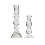 Two clear glass candle holders on a white background