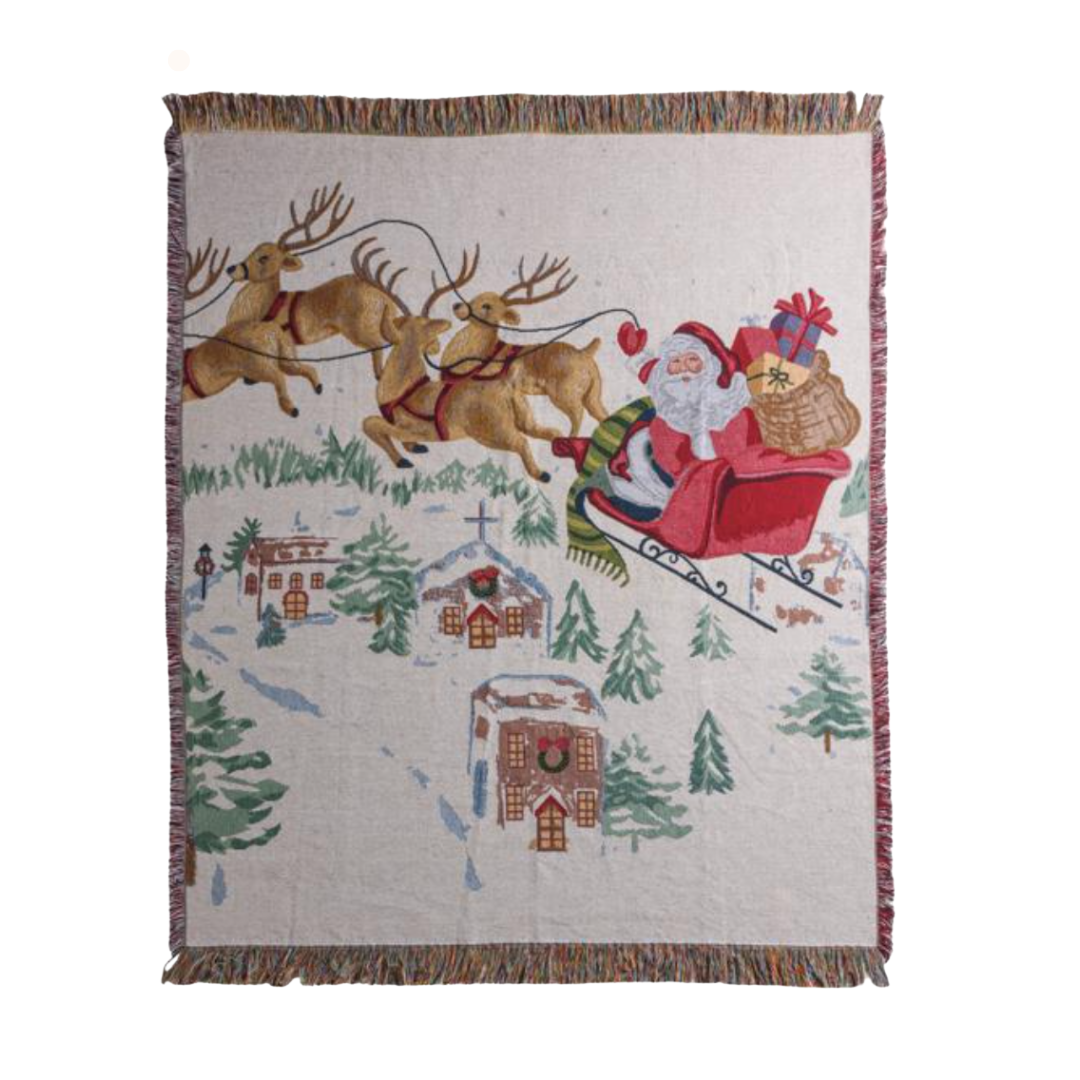 Woven blanket with Santa Claus and reindeer design on a white background