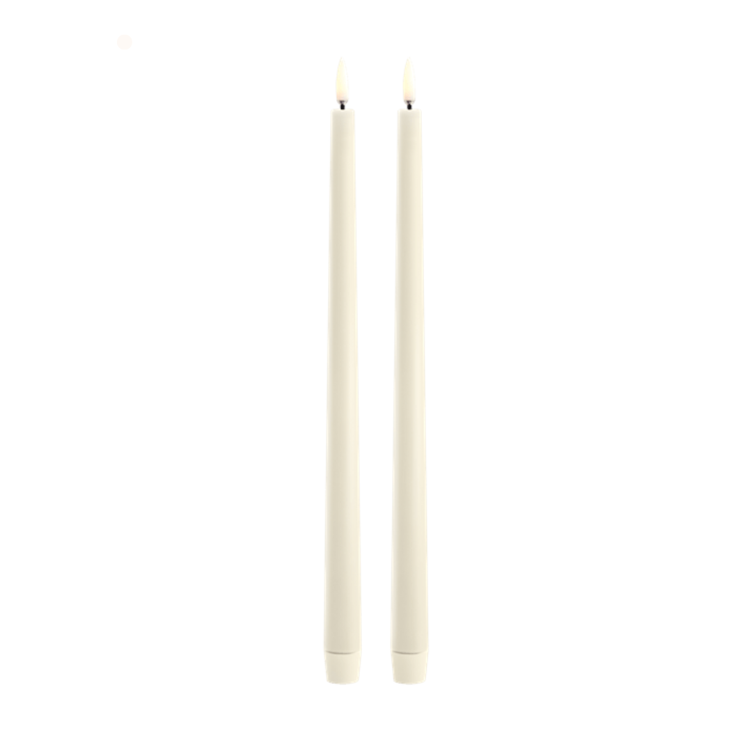 Two vanilla candles on a white background