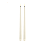 Two vanilla candles on a white background