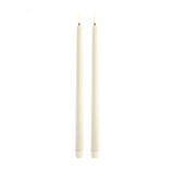 Two vanilla candles on a white background