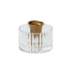 Clear glass candle holder with gold base on a white background