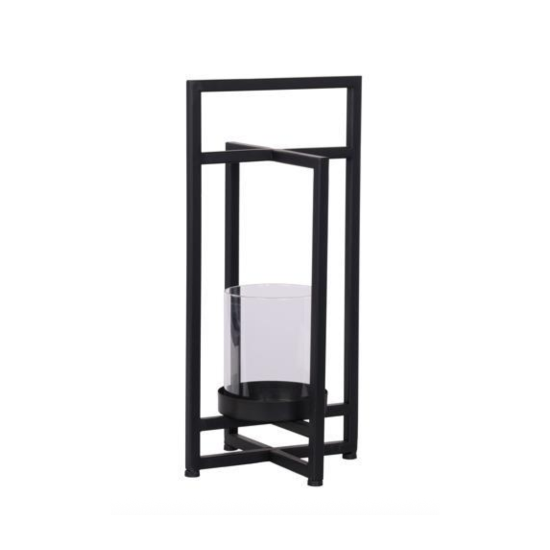 Black metal candle holder with a white candle on a white background