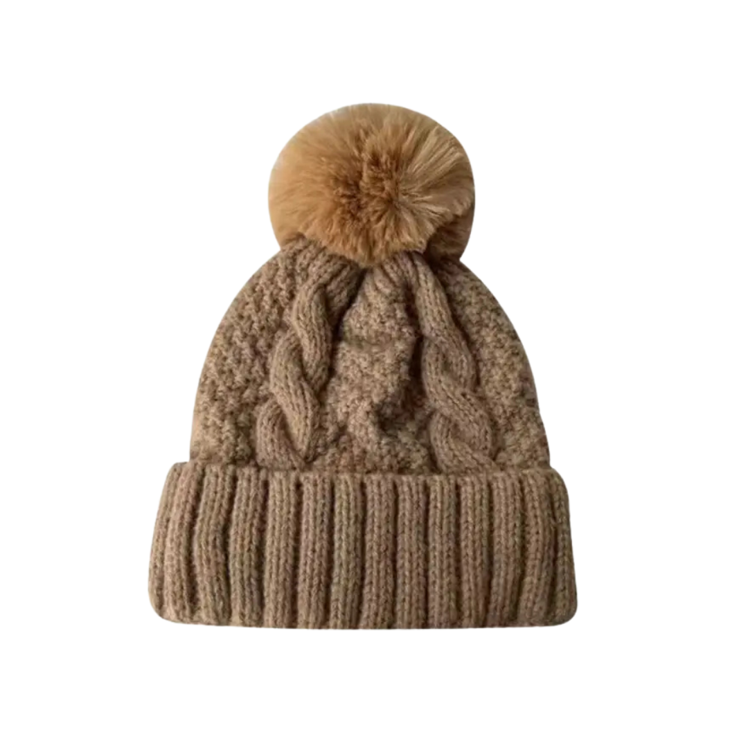 Brown knitted beanie with a pom-pom on a white background