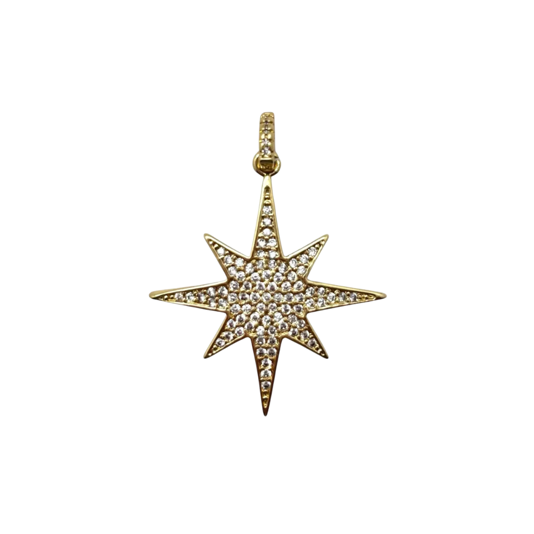 Gold star-shaped pendant with embedded stones on a white background