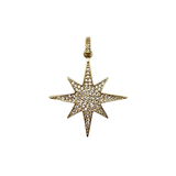 Gold star-shaped pendant with embedded stones on a white background