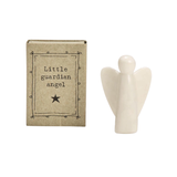 Small white porcelain guardian angel figurine displayed beside a brown kraft gift box labeled “Little Guardian Angel"