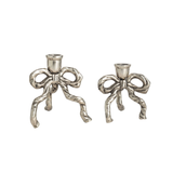 Two silver bow-shaped candle holders on a white background