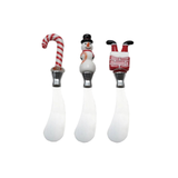 Three Christmas-themed ceramic spreaders with candy cane, snowman, and Santa Claus handles on a white background.