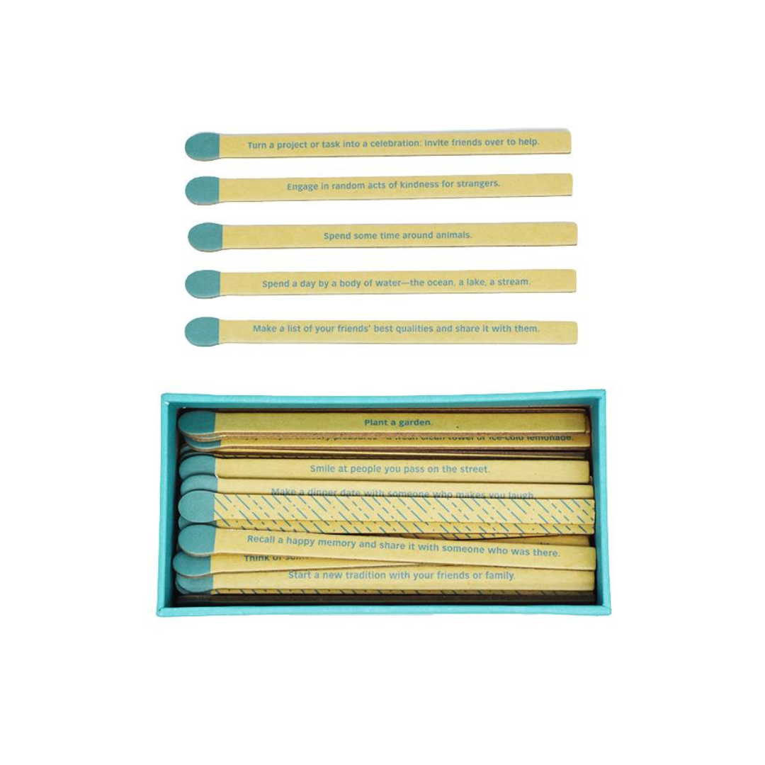 Set of yellow matches with blue tips in a teal box on a white background