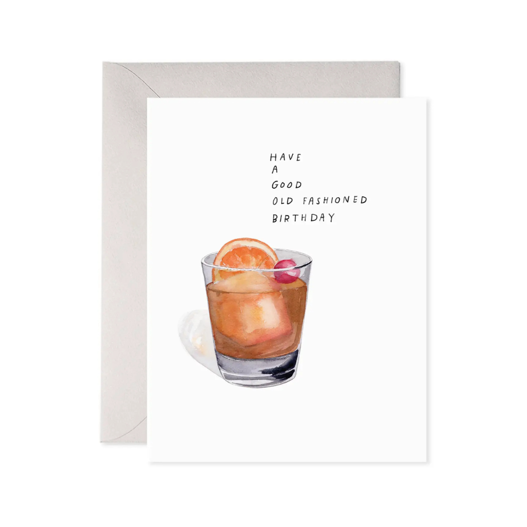 Greeting card with a cocktail illustration and text 'Have a good old fashioned birthday' on a white background.