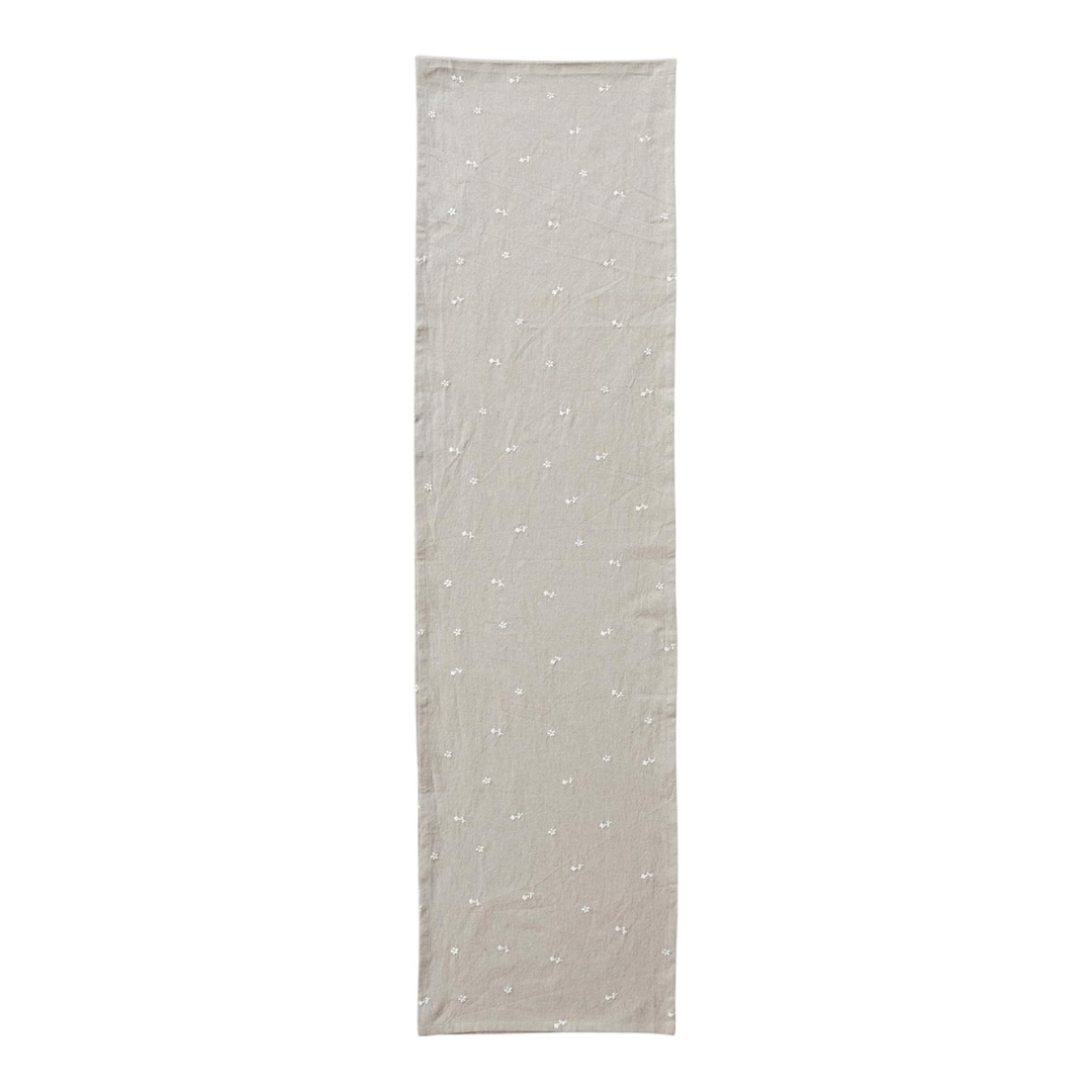 Long rectangular table runner with subtle pattern on a white background