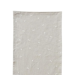 Gray table runner with small white floral patterns on a white background