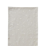 Gray table runner with small white floral patterns on a white background