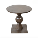 Wooden round table with a unique base design on a white background