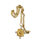 Gold necklace with a pendant and pearl accents on a white background