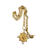 Gold necklace with a pendant and pearl accents on a white background